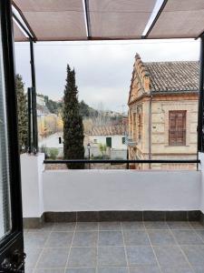 a view of a building from an open window at La casita del río 2 in Granada