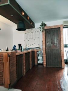 a kitchen with wooden floors and a wooden door at La casita del río 2 in Granada