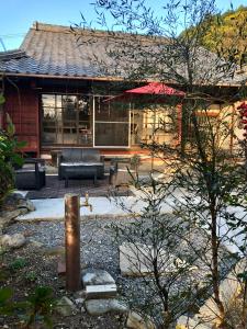 a house with a patio in front of it at Kumano Winery Guest House in Tanabe