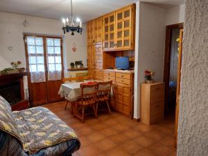 a kitchen with a table and a dining room at Casa Vittoria in Rivisondoli