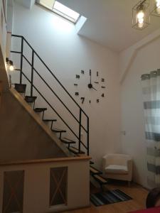 salon z zegarem na ścianie w obiekcie Apartament z antresolą w mieście Darłowo