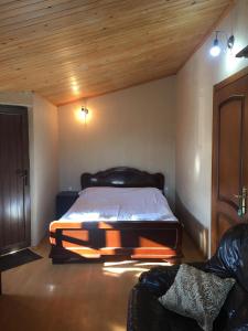 a bedroom with a bed and a desk at Hotel Prime in Mtskheta