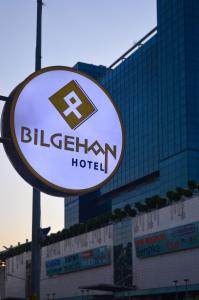 a sign for a bilsteinen hotel in front of a building at Bilgehan Hotel in Antalya