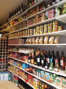 a store shelf filled with lots of bottles of wine at Chateau des Fontenelles in Chavagne