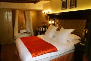 a bedroom with a large bed with a red blanket at Tonic Hotel Saint Germain des Prés in Paris