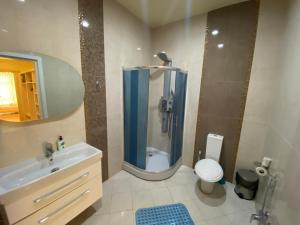 La salle de bains est pourvue d'une douche, de toilettes et d'un lavabo. dans l'établissement Modern City Center Apartments, à Baku