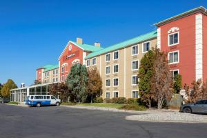 a building with a car parked in a parking lot at Comfort Inn West Valley - Salt Lake City South in West Valley City