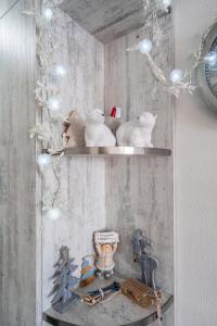 a shelf with some figurines on it in a room at Gudauri Cozy Home in Gudauri