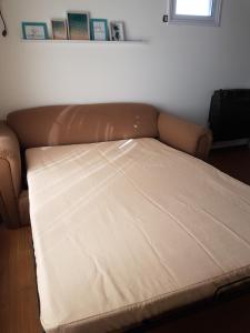 NidoAparte Departamento Lujan Centro في لوجان: كنب جالس في غرفة بسرير