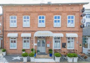 a brick building with a sign that reads morrilka at Rumpelstilzchen in Westerland