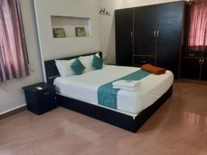 MarudhamalaiSremethila Homestay的卧室里有一张大床，配有蓝色枕头