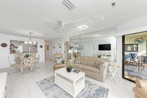 a living room with a couch and a table at Anna Maria Island Beach Sands 203 in Bradenton Beach
