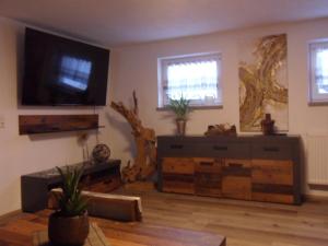 a living room with a flat screen tv on the wall at Luxusferienwohnung-Mager in Freyung