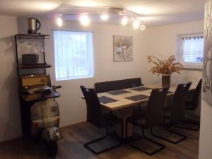 a dining room with a table and a scooter at Luxusferienwohnung-Mager in Freyung