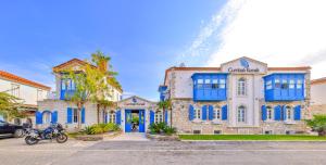 a building with blue windows and a tower at Cumbali Konak Hotel (Adults Only +12) in Alacati