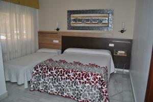 Postel nebo postele na pokoji v ubytování Hotel Albero