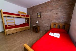 En eller flere senger på et rom på Hosteria Villa Santa Clara del Atuel