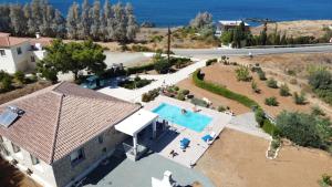 an aerial view of a house with a swimming pool at Pomos Idol Exceptional Beach Villa in Pomos