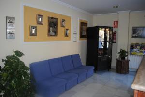 
a living room filled with furniture and a blue couch at Hotel Albero in Granada
