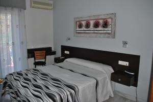 Postel nebo postele na pokoji v ubytování Hotel Albero
