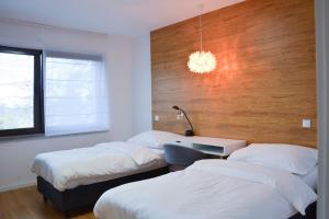 a bedroom with two beds and a desk with a lamp at Luxury apartment with private sauna Pod Javorovým in Třinec