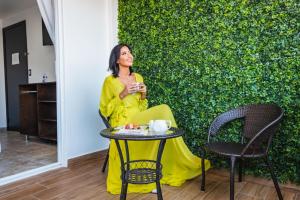 a woman sitting at a table in front of a wall at Hotel Revolución in Tijuana +77 photos