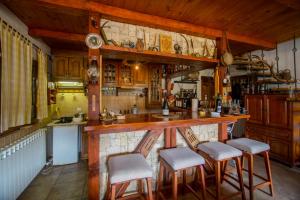 a kitchen with a bar with stools in it at Guest House Lovcen in Cetinje