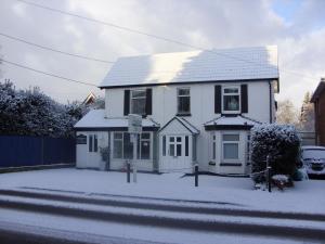 a white house with snow in front of it at Ashdene Guest House in Southampton