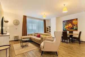 a living room with a couch and a table at Sunset Silver Mountain in Poiana Brasov