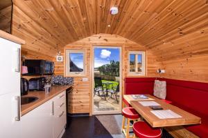 a kitchen in a tiny house with a wooden ceiling at Tigh an Each B&B & Laggan Glamping in Newtonmore