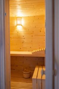 a sauna with a light in a wooden wall at Vacation house Kula in Jasenak +12 photos
