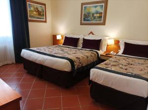Postel nebo postele na pokoji v ubytování Hotel Maxim Axial