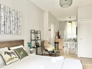 a bedroom with a bed and a living room at Arina & Julien Dieppe in Dieppe