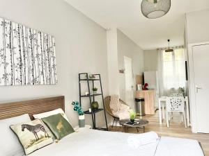 a bedroom with a bed and a living room at Arina & Julien Dieppe in Dieppe