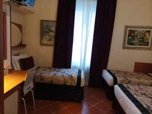 Postel nebo postele na pokoji v ubytování Hotel Maxim Axial