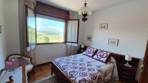 a bedroom with a bed and a large window at Tercero Loft Susana in San Vicente de la Barquera +7 photos