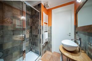a bathroom with a shower and a toilet and a sink at Albergo San Carlo in Ormea