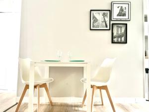 a white table and two white chairs in a room at Arina & Julien Dieppe in Dieppe