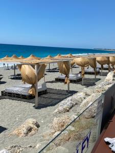 a beach with chairs and umbrellas and the ocean at MOOD Sea Stage in Castiglione