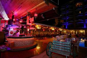 a restaurant with a bar with people sitting at tables at Kleopatra Fatih Hotel in Alanya +87 photos