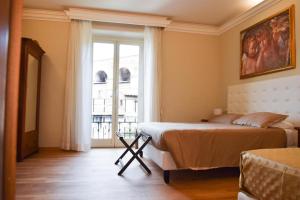 a bedroom with a bed and a large window at Hotel Salis in Rome