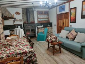 a living room with a blue couch and a table at Molino Elidio in Pontones