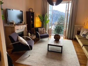 a living room with a couch and chairs and a tv at Ancient Hotel Mont Joly - 3 bedr - view - 2 bath - 80m2 in Saint-Gervais-les-Bains