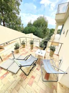 two chairs and a table on a patio at Casa Serra in Porto Palo