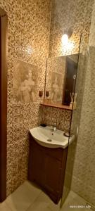 a bathroom with a sink and a mirror at Confort Flat in Braşov +15 photos