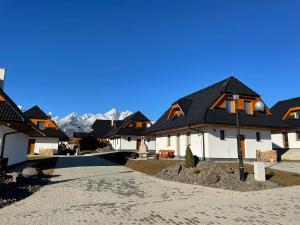 una fila de casas con montañas en el fondo en Vila Alila, en Stará Lesná