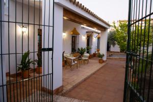 an external view of a house with a fence at El Molino del Huertezuelo in La Palma del Condado