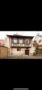 a large house with a fence in front of it at Chez Ben et Maé in Rouffach