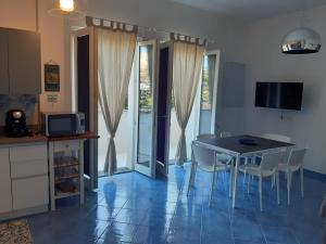 a kitchen and dining room with a table and chairs at Chiara's apartment Procida in Procida