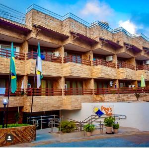 a building with flags in front of it at Flat Luxo 213 - Pipas Bay in Pipa